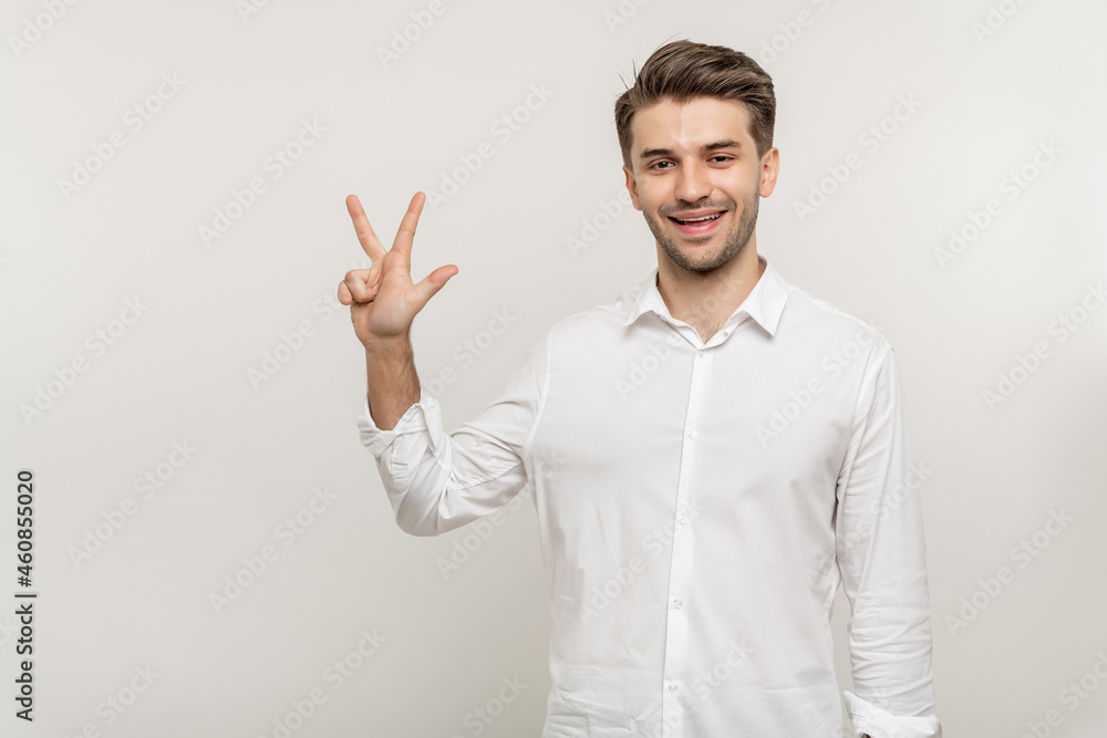 Young handsome man over isolated white background showing three fingers while smiling confident and happy Young handsome man over isolated white background showing three fingers while smiling confident and happy