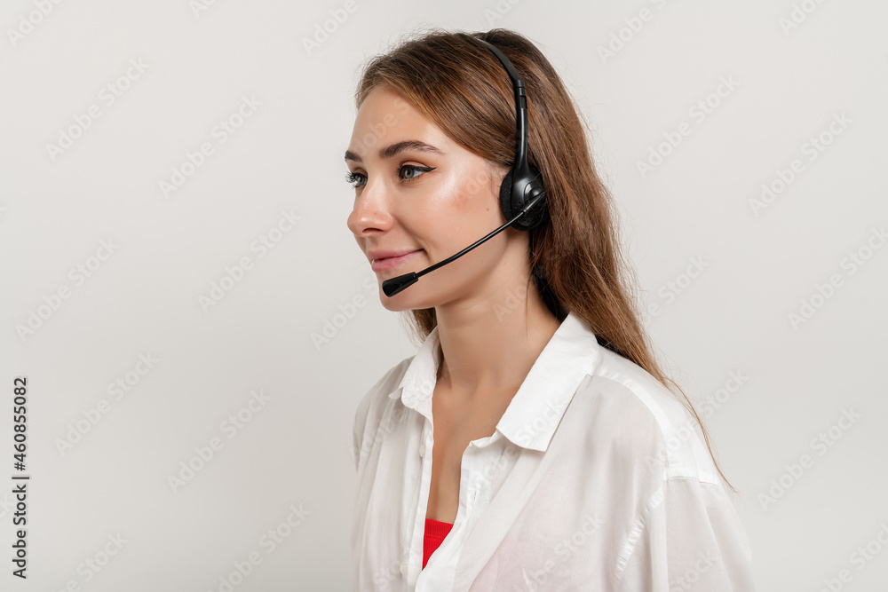attractive smiling woman working with headset answering business calls as tech support dispatcher isolated over white background attractive smiling woman working with headset answering business calls as tech support dispatcher isolated over white background