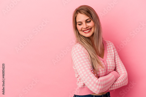 Young russian woman isolated on pink background smiling confident with crossed arms.