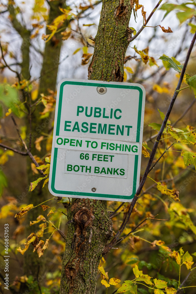 Easement sign to notify public fishing is allowed. Selective focus, background and foreground blur.
