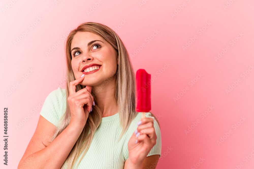 Young russian woman holding an ice cream isolated on pink background Young russian woman holding an ice cream isolated on pink background