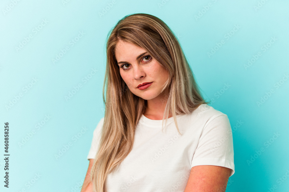 Young russian woman isolated on blue background Young russian woman isolated on blue background