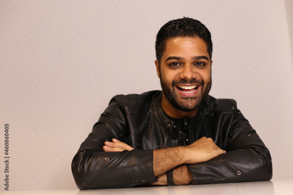 Brazilian black man with leather jacket working home office on computer Brazilian black man with leather jacket working home office on computer