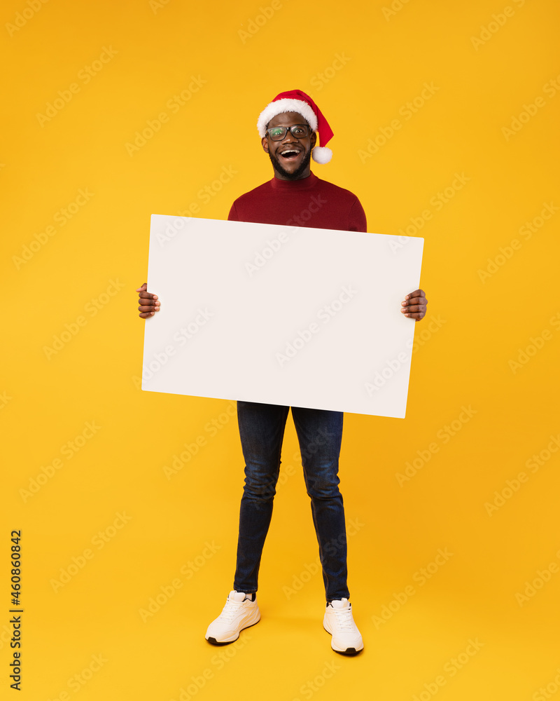 African Man Showing Blank Paper Board For Christmas Advertisement, Studio African Man Showing Blank Paper Board For Christmas Advertisement, Studio