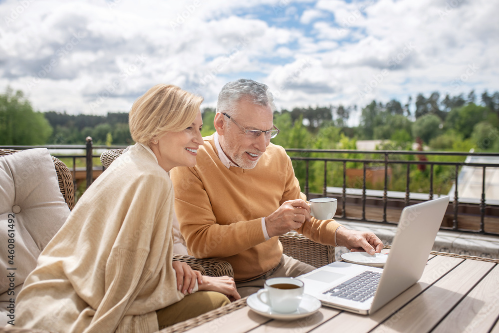 Pleased married couple focused on surfing the net Pleased married couple focused on surfing the net
