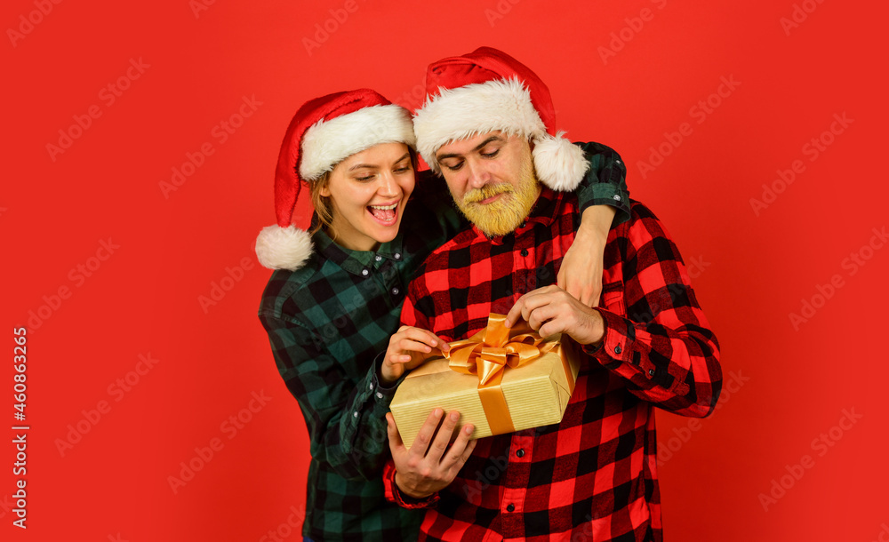 Fototapeta premium Couple in love with gift. Christmas time. Man and woman christmas holiday celebration. Giving present. Love and care. Spread love. Family shopping. Surprise for spouse. Buy present. Christmas party
