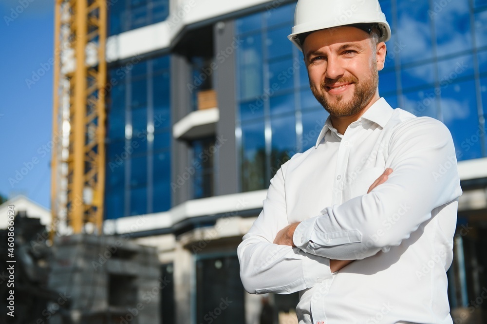 A construction worker control in the construction of roof structures on construction site and sunset background A construction worker control in the construction of roof structures on construction site and sunset background