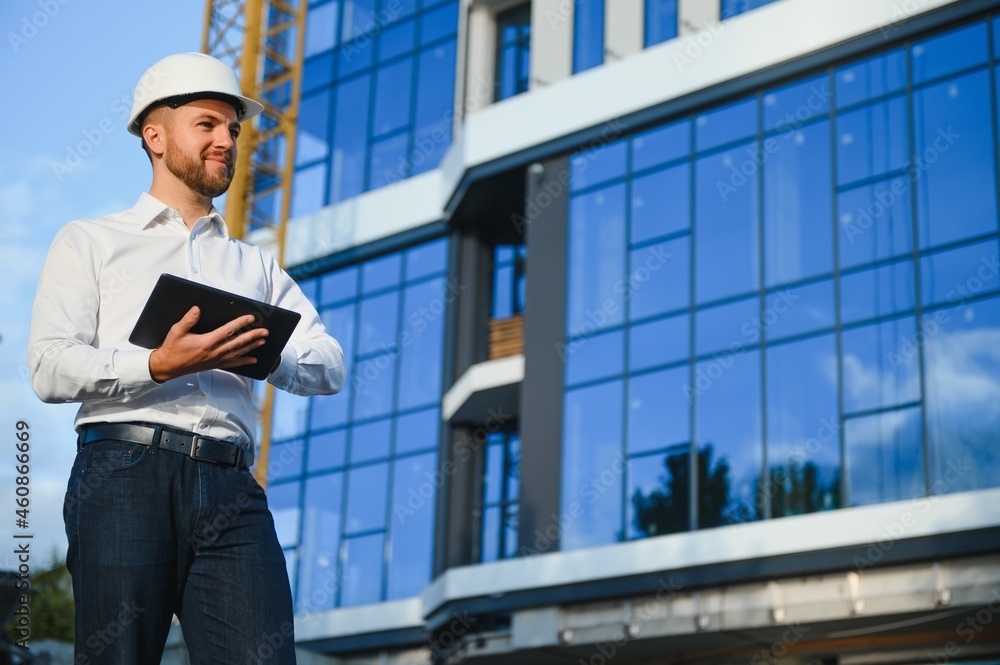 Industrial theme: constructor standing at a site area. Industrial theme: constructor standing at a site area.