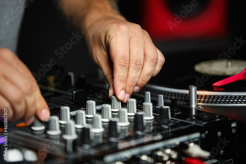 Disc jockey mixing music. Dj audio equipment on hip hop party in night club. 