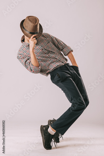 a boy dancing in a hat