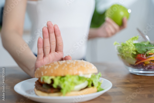 Women avoid fast food during diet sessions to lose weight and choose healthy food that has vitamins and nutrition. photo
