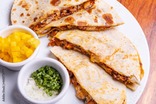 Shepherd's meat tacos with corn tortillas. Gringa with cheese. Mexican food on wooden background. Mexican gringa with hot sauce. Mexican taco concept. Mexican food concept. photo
