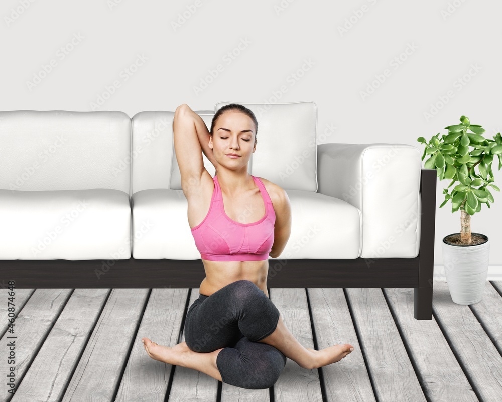 The girl does yoga, woman at home practices asanas. Hands on chest, mudra. The girl does yoga, woman at home practices asanas. Hands on chest, mudra.