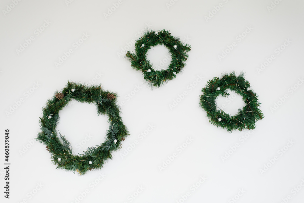 Christmas wreaths with fir tree on white wall wall Christmas wreaths with fir tree on white wall wall