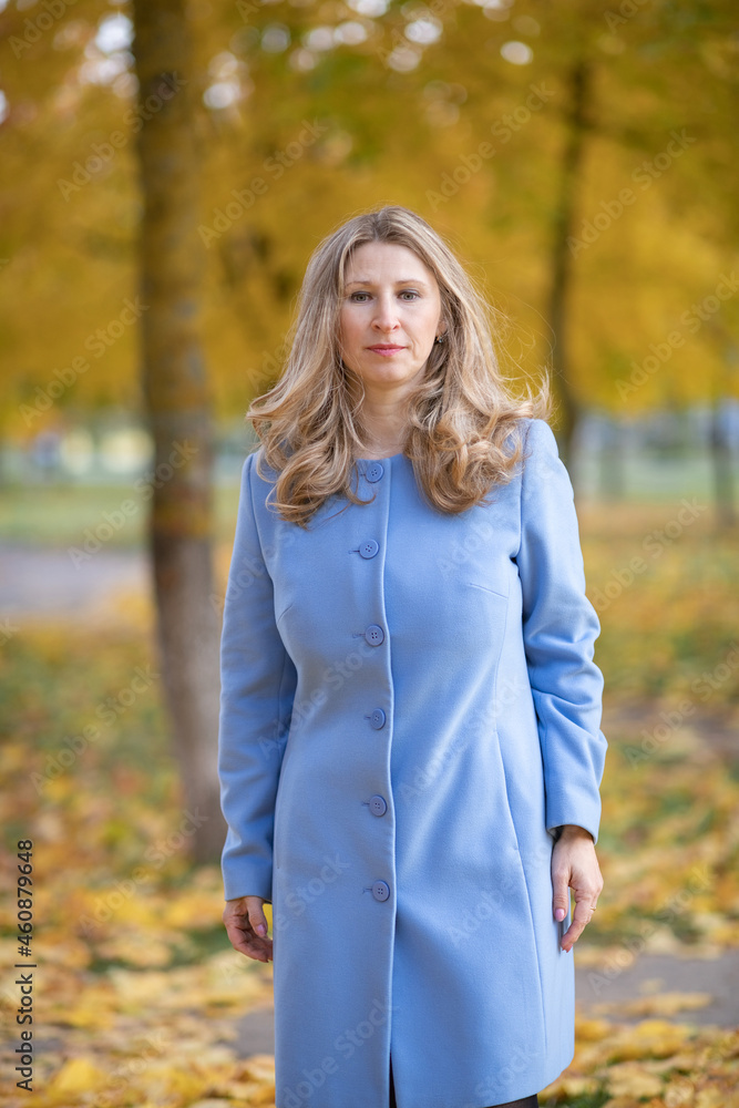 Young beautiful blonde girl in an autumn park in the maple leaves.
Young beautiful blonde girl in an autumn park in the maple leaves.