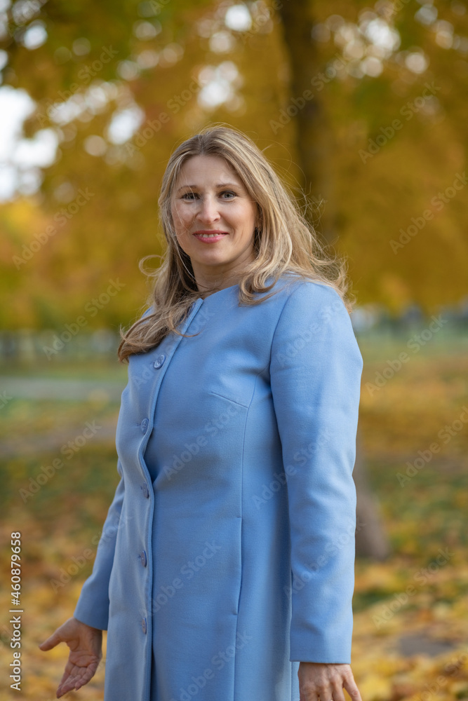 Young beautiful blonde girl in an autumn park in the maple leaves.
Young beautiful blonde girl in an autumn park in the maple leaves.