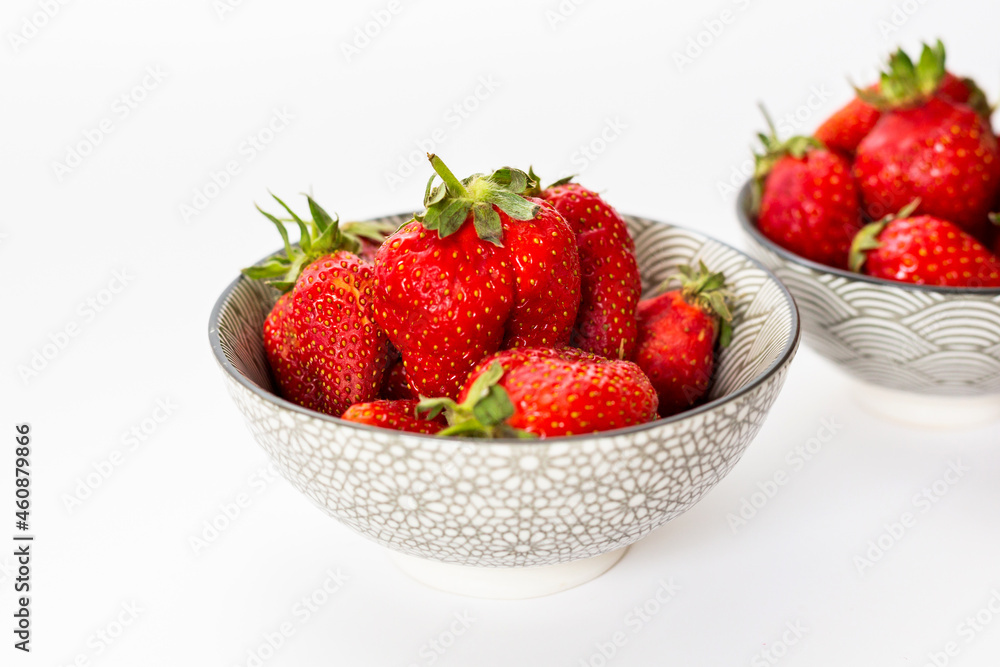 Strawberries in round plates, arranged on a white background. Strawberries in round plates, arranged on a white background.