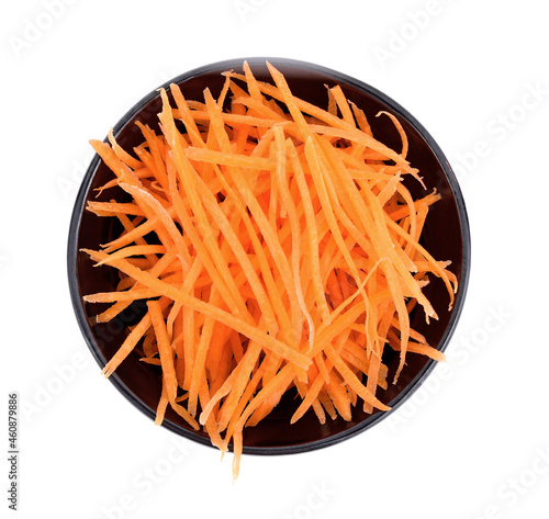 Grated carrot in small black bowl on white background