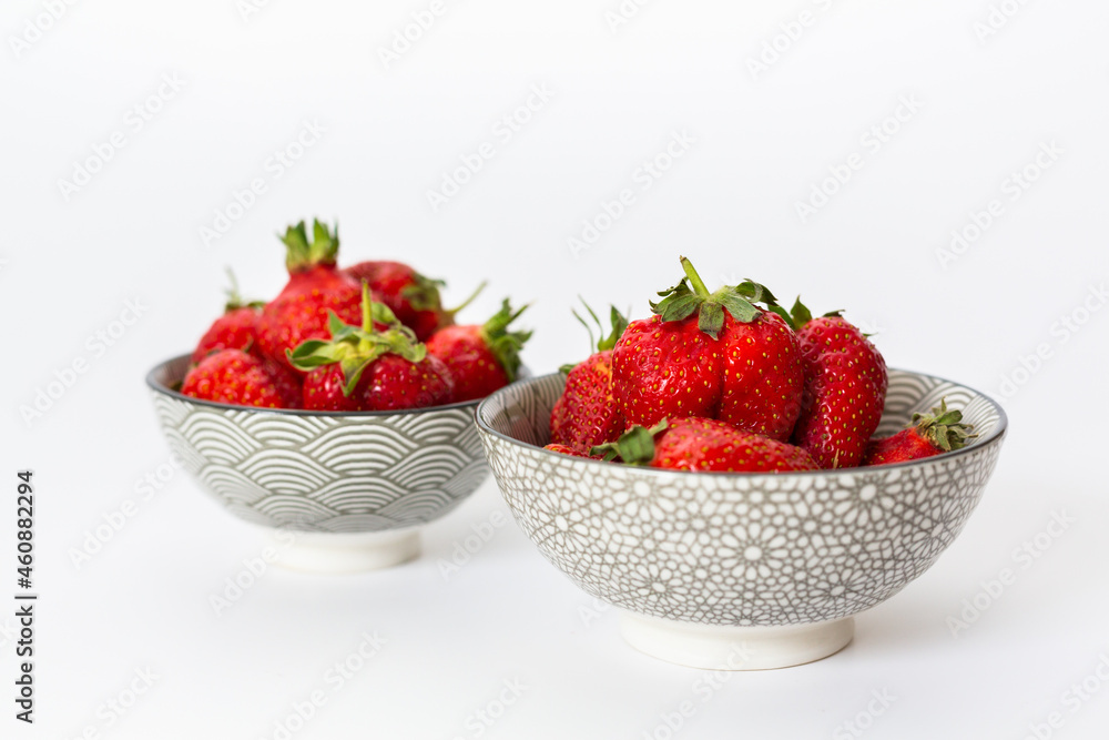 Strawberries in round plates, arranged on a white background. Strawberries in round plates, arranged on a white background.