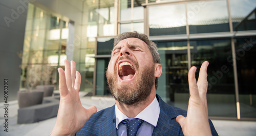 frustrated shouting bearded businessman in formal suit, bankruptcy