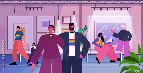 gay couple looking creative contemporary paintings artworks or exhibits in modern art gallery transgender love LGBT