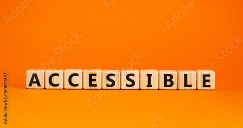 Accessible symbol. The word accessible on wooden cubes. Beautiful orange table, orange background. Business and accessible concept. Copy space.