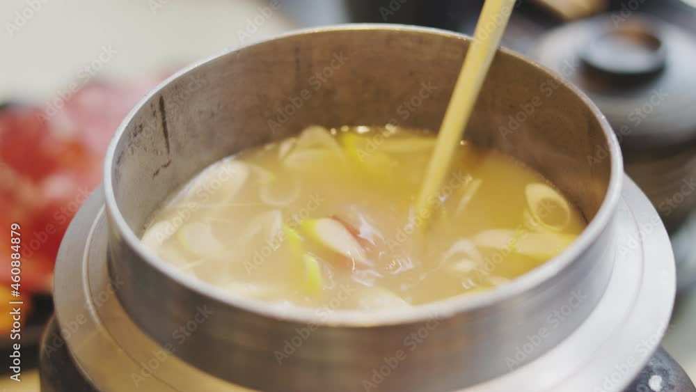 Close up 4K of eating shabu which is japanese style hot pot meal by putting sliced raw meat (pork and beef) in boiled soup and vegetable. It is healthy and delicious food, especially for winter. Close up 4K of eating shabu which is japanese style hot pot meal by putting sliced raw meat (pork and beef) in boiled soup and vegetable. It is healthy and delicious food, especially for winter.