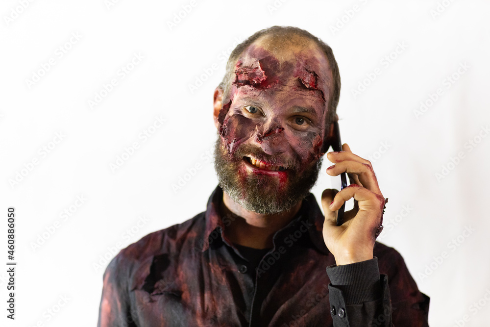 Zombie male speaking mobile phone on white background halloween concept Zombie male speaking mobile phone on white background halloween concept