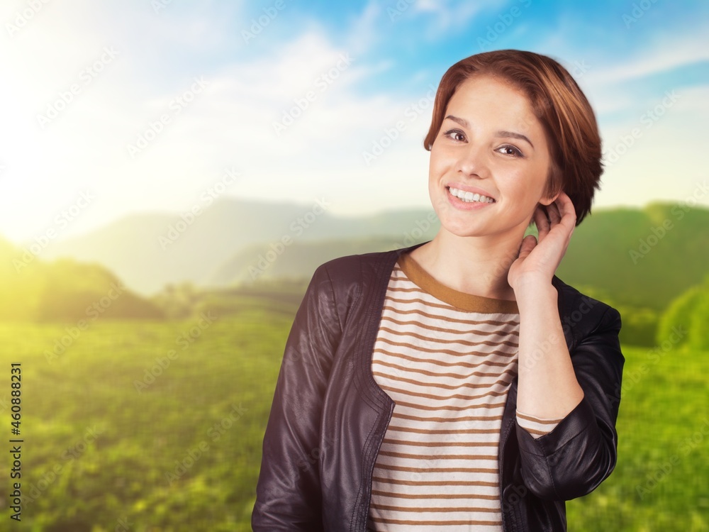 Romantic young woman poses and smiles in the park. Summer fashion and beauty. Romantic young woman poses and smiles in the park. Summer fashion and beauty.