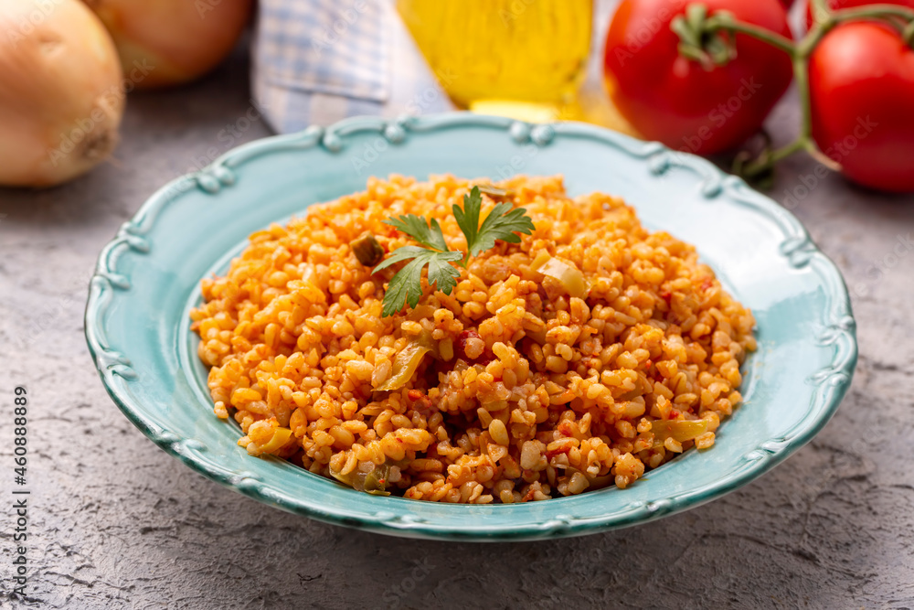 Traditional turkish bulgur pilaf with tomato sause in plate (Turkish name; meyhane pilavi) Traditional turkish bulgur pilaf with tomato sause in plate (Turkish name; meyhane pilavi)