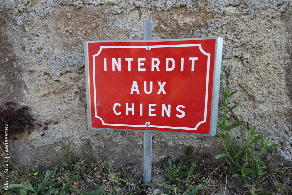 A red and white French warning sign that says: A red and white French warning sign that says: