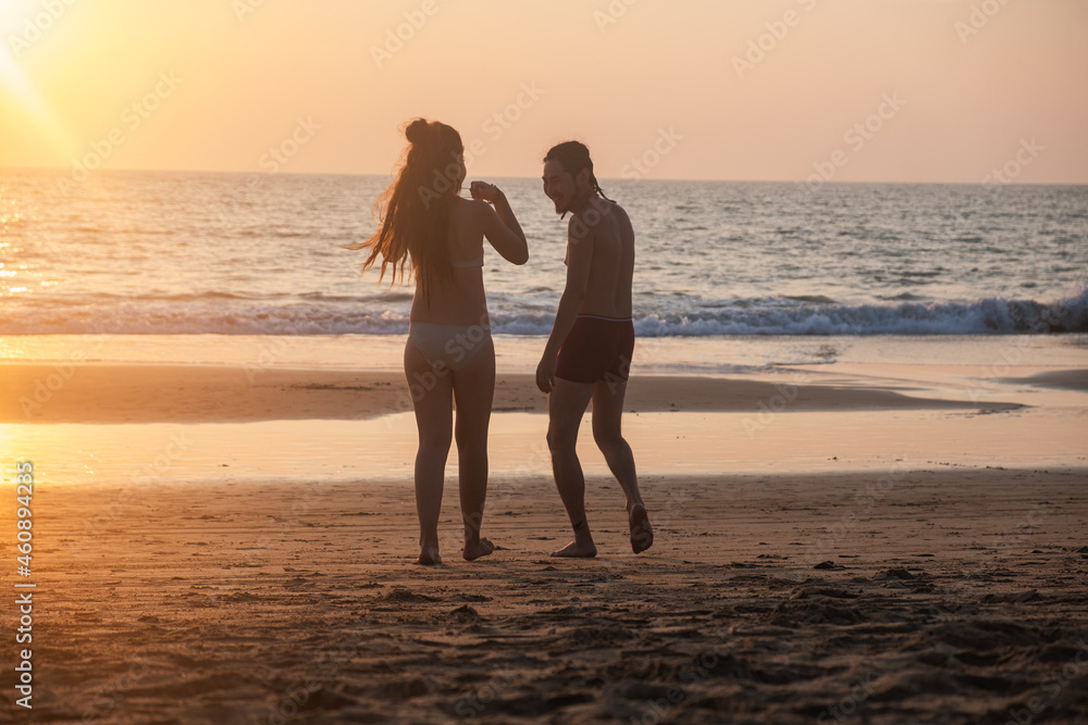 Silhouette of a young couple together at the beach