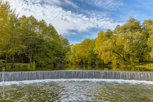Artificial waterfall in the Drozdy Forest Park in Minsk, Belarus. Autumn landscape. photo