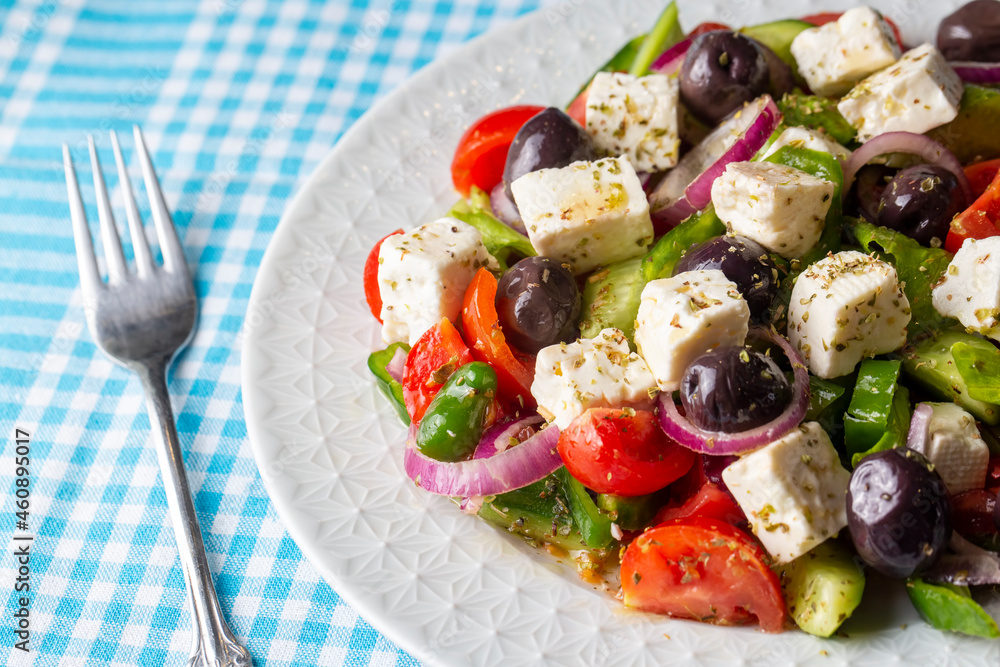 Greek salad with fresh vegetables, feta cheese and kalamata olives. Healthy food.