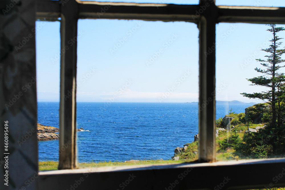 View through a window of the coastline and looking beyond, out over the Atlantic Ocean to the horizon.
