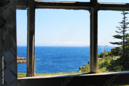 View through a window of the coastline and looking beyond, out over the Atlantic Ocean to the horizon.