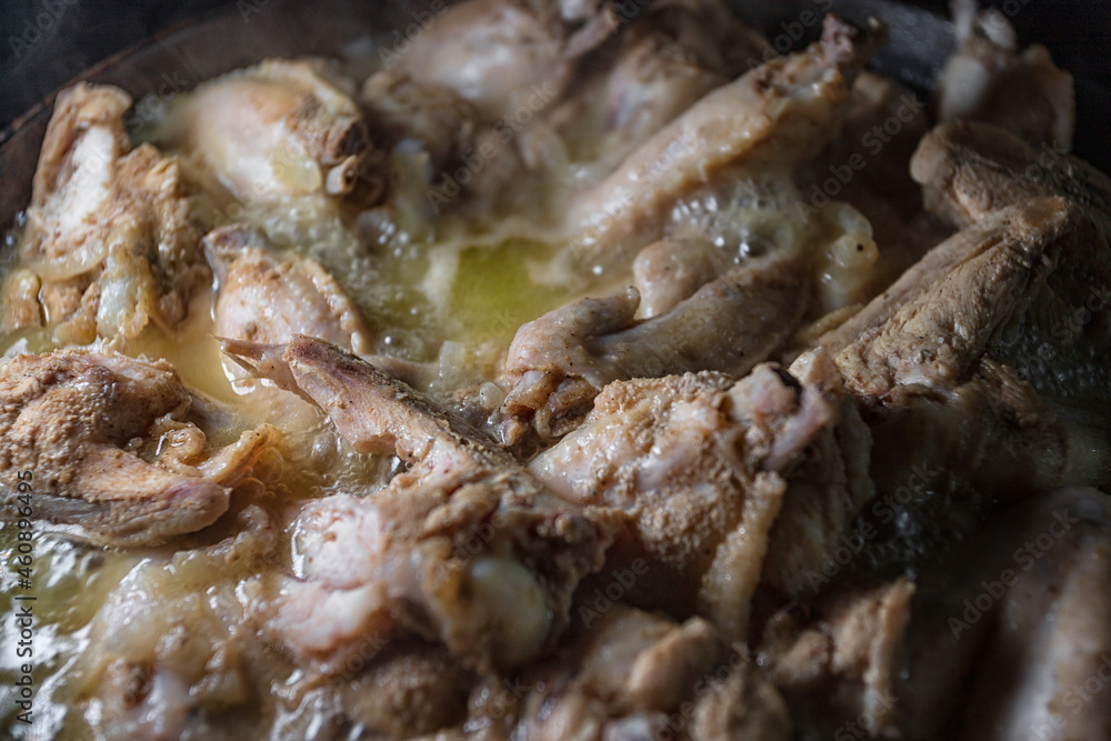 Chicken wings are cooked in their own juice in a pan Chicken wings are cooked in their own juice in a pan