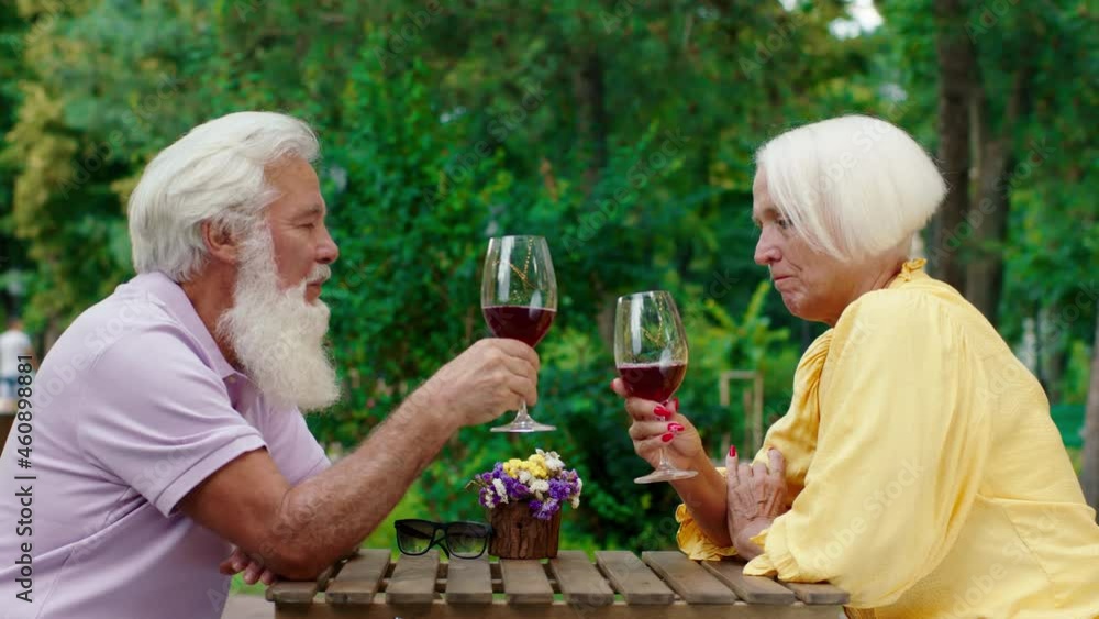Romantic time for a couple old looking very excited they cheers with wine glasses and feeling relaxed Romantic time for a couple old looking very excited they cheers with wine glasses and feeling relaxed