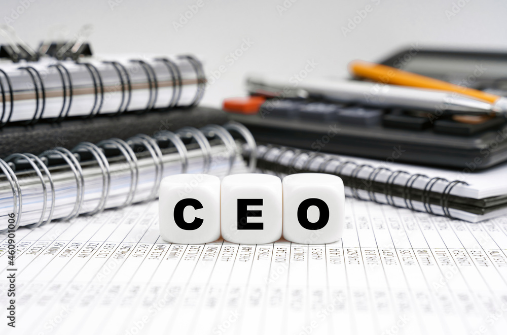 On the table, among office objects, cubes with the inscription - CEO On the table, among office objects, cubes with the inscription - CEO