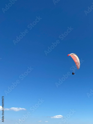 Skydiver flies under the canopy of a parachute, quickly approaching, close-up