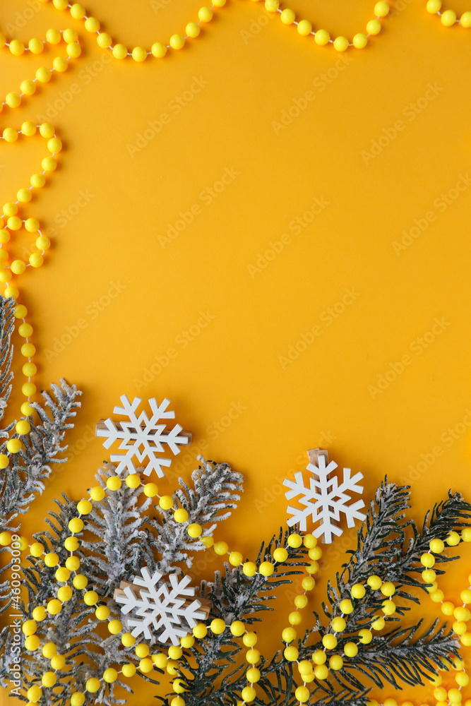 christmas card mockup. frame from fir branches of snowflakes and Christmas tree decorations on a yellow background. invitation. congratulation christmas card mockup. frame from fir branches of snowflakes and Christmas tree decorations on a yellow background. invitation. congratulation