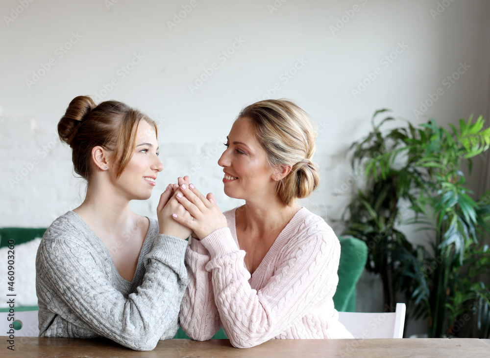 Happy young woman and her mother at home, happy family
