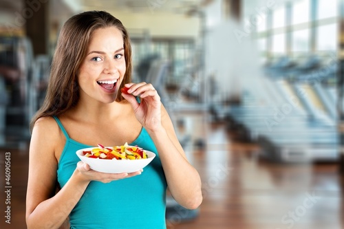 Portrait of attractive woman hold salad bowl and look at camera.