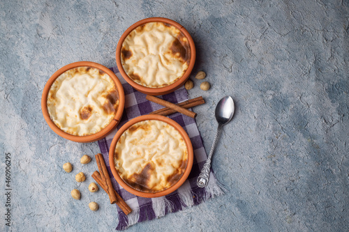 Baked rice pudding turkish milky dessert sutlac in earthenware casserole with hazelnuts