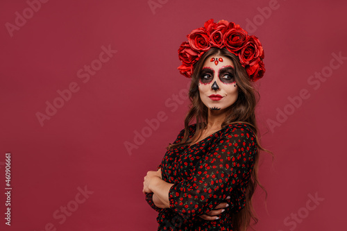 Quadro em tela Beautiful girl in la muerta attire and skull make up looking to camera during ha