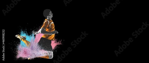 The professional football, soccer player in explosion of colored powder