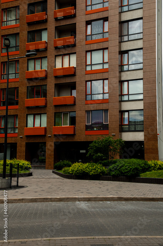Modern urban architecture; brown walls and large black windows of apartments, offices, companies.