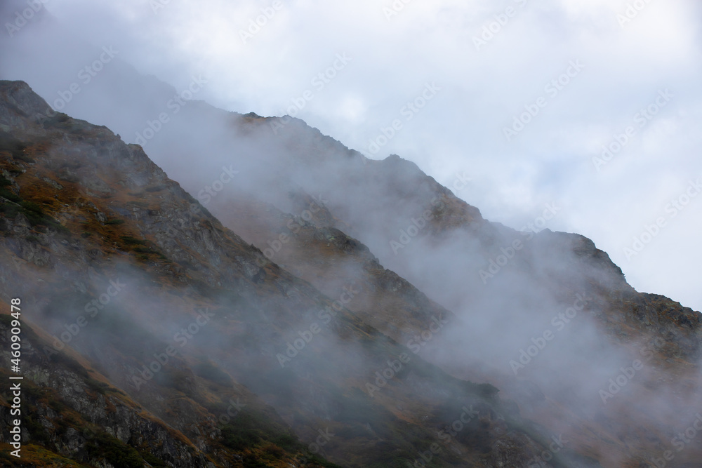 The slopes of a mountain in the fog