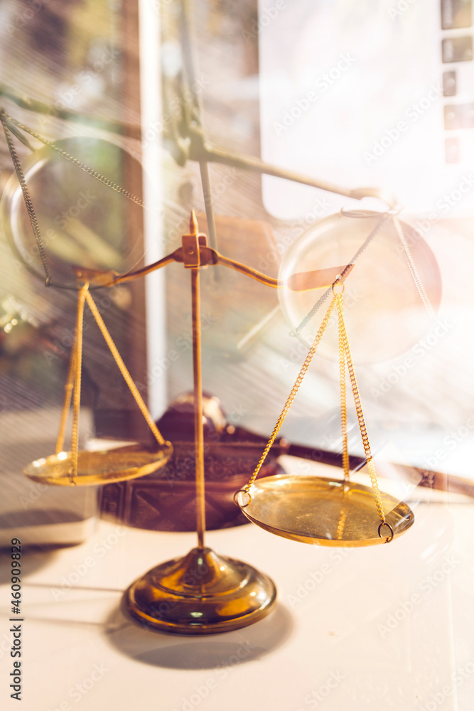 Business and lawyers discussing contract papers with brass scale on desk in office. Law, legal services, advice, justice and law concept picture with film grain effect Business and lawyers discussing contract papers with brass scale on desk in office. Law, legal services, advice, justice and law concept picture with film grain effect