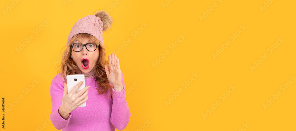 woman wearing winter clothes and mobile phone isolated on background